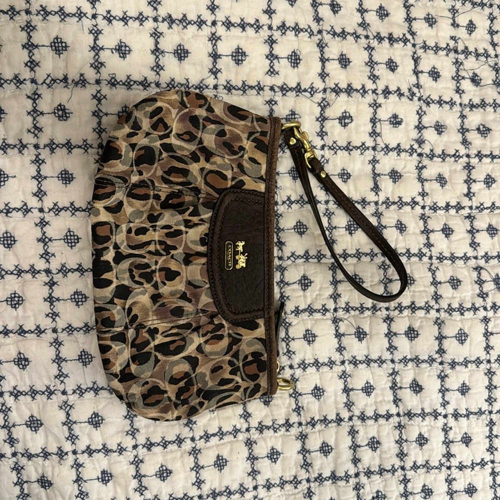 Coach wristlet - fair condition. Cheetah print with leather trim.